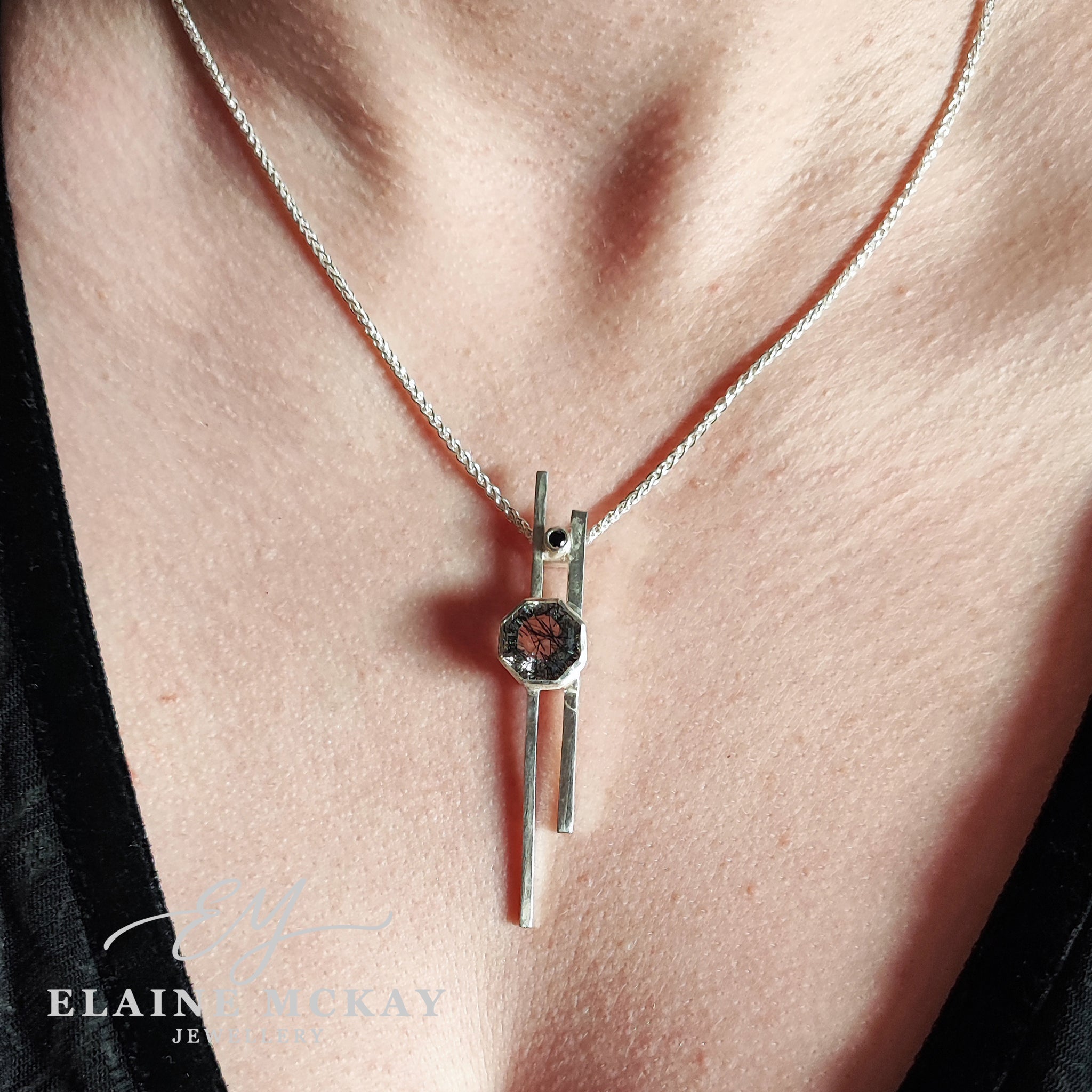 Tourmalated quartz and black cubic zirconia pendant