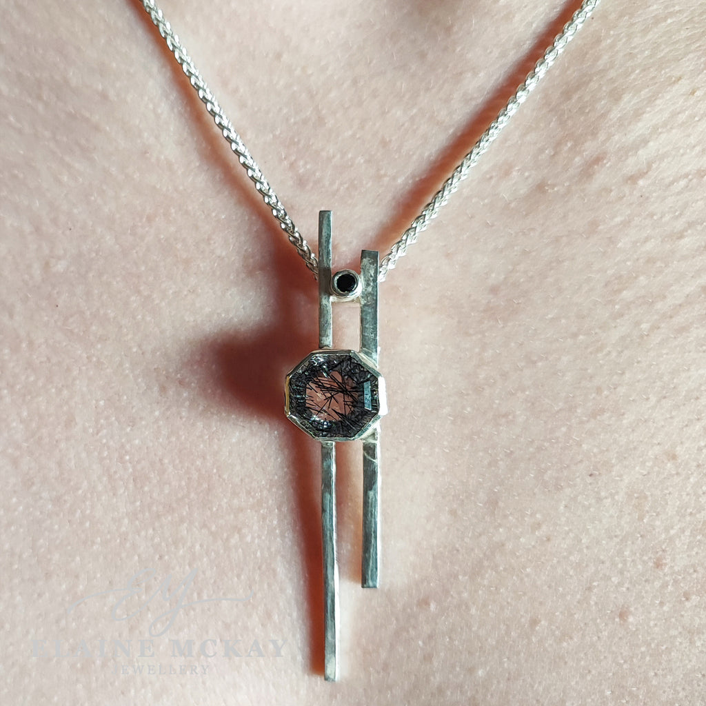 Tourmalated quartz and black cubic zirconia pendant