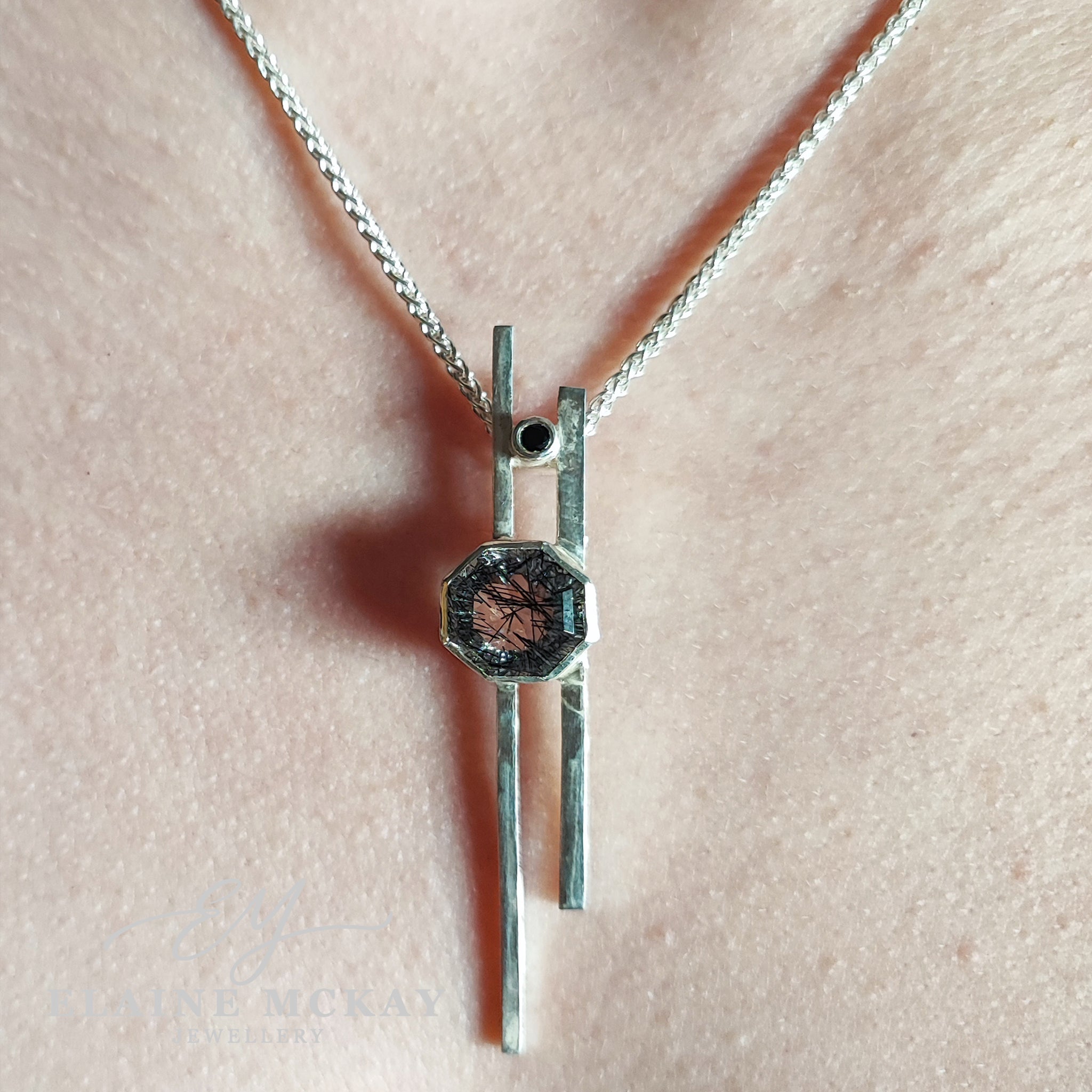Tourmalated quartz and black cubic zirconia pendant