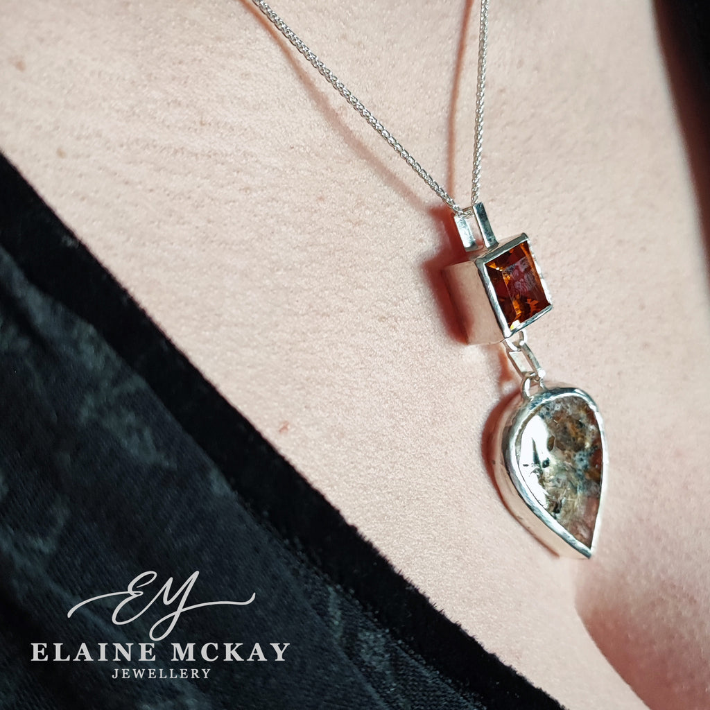 Silver pendant with Citrine & quartz gemstones on a chain, displayed on a person's neck with 'Elaine McKay Jewellery' branding.