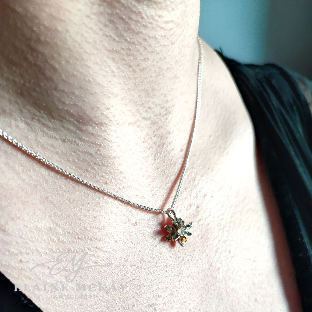 Necklace with a floral pendant on a model