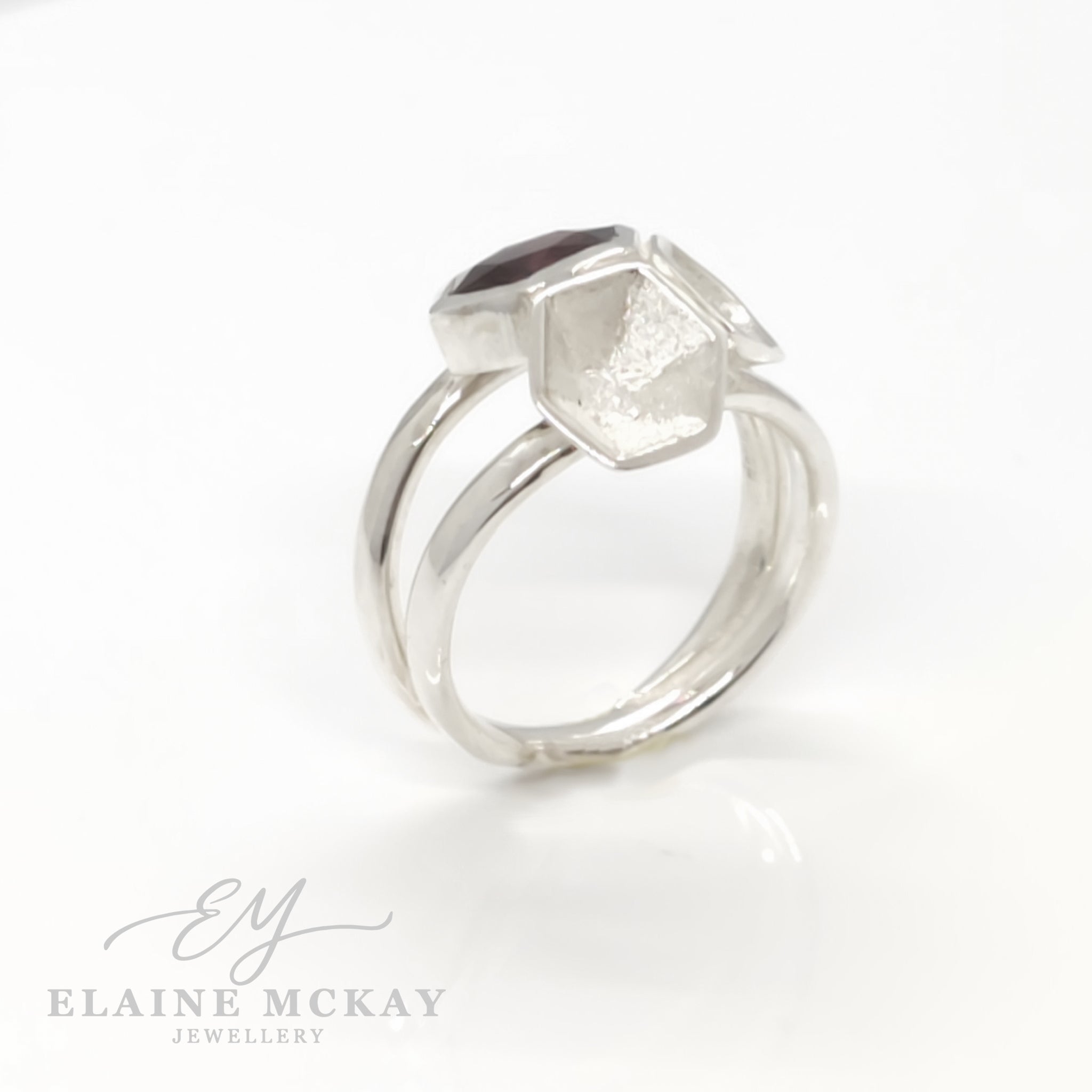Silver ring with geometric design on a white background, branded 'Elaine McKay Jewellery'.