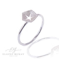 Hex silver ring with a star pierced out of center on a white background