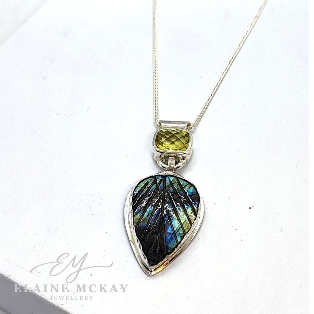Lemon quartz and carved Leaf Labradorite pendant on a white background