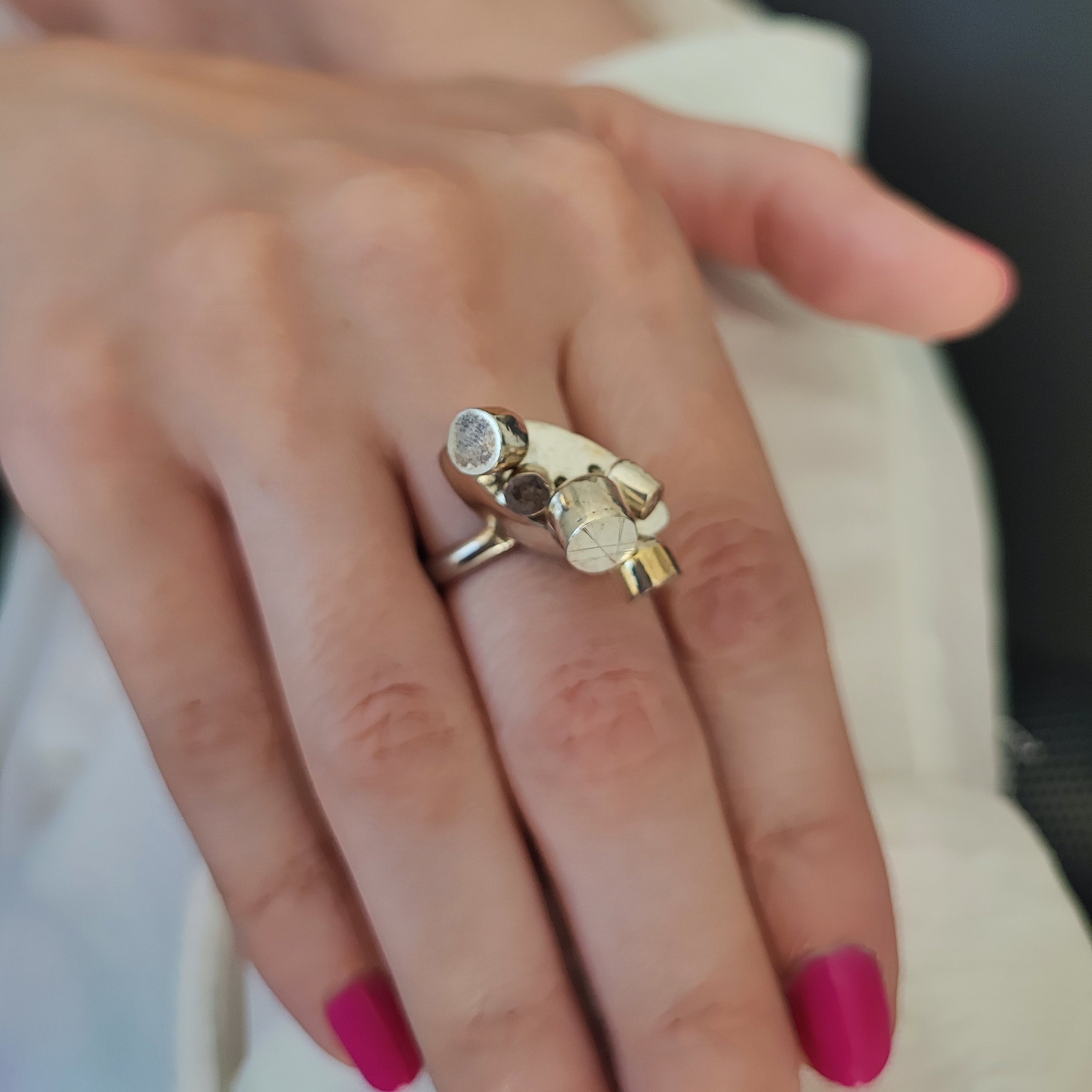 Models hand displaying pod ring on center finger