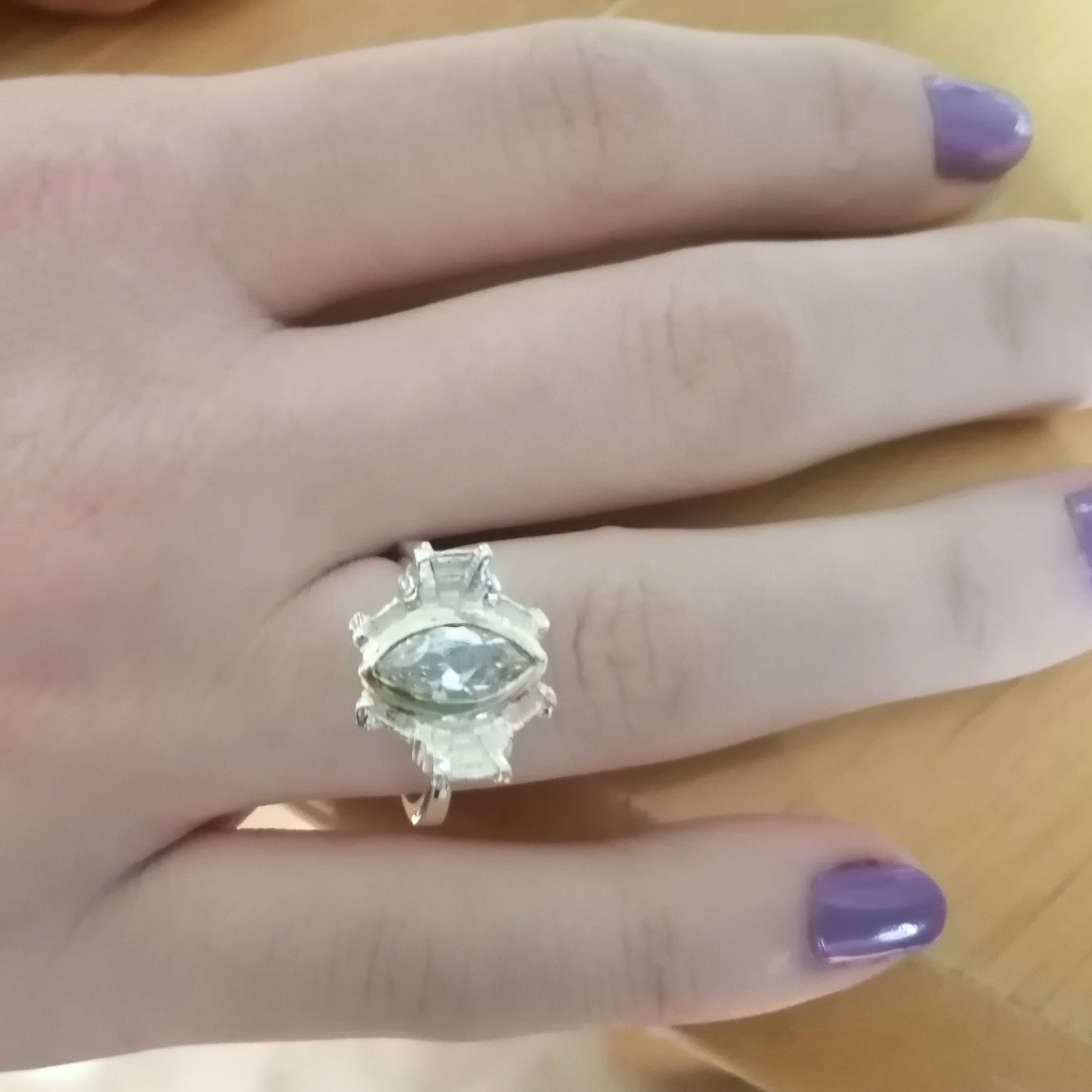 Model wearing a reflect silver ring with a cubic zirconia gemstone 