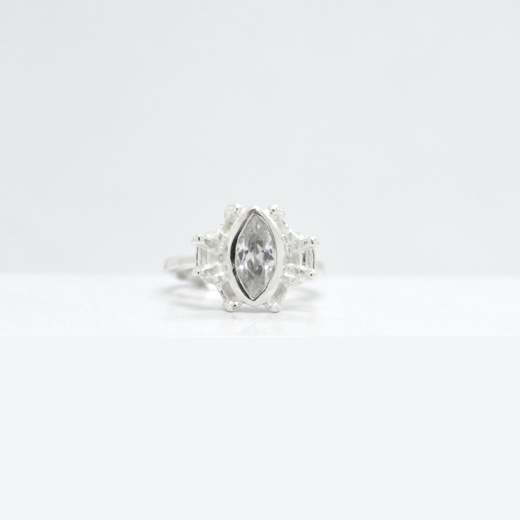 Silver ring with a large marquise shaped cubic zirconia on a  white background
