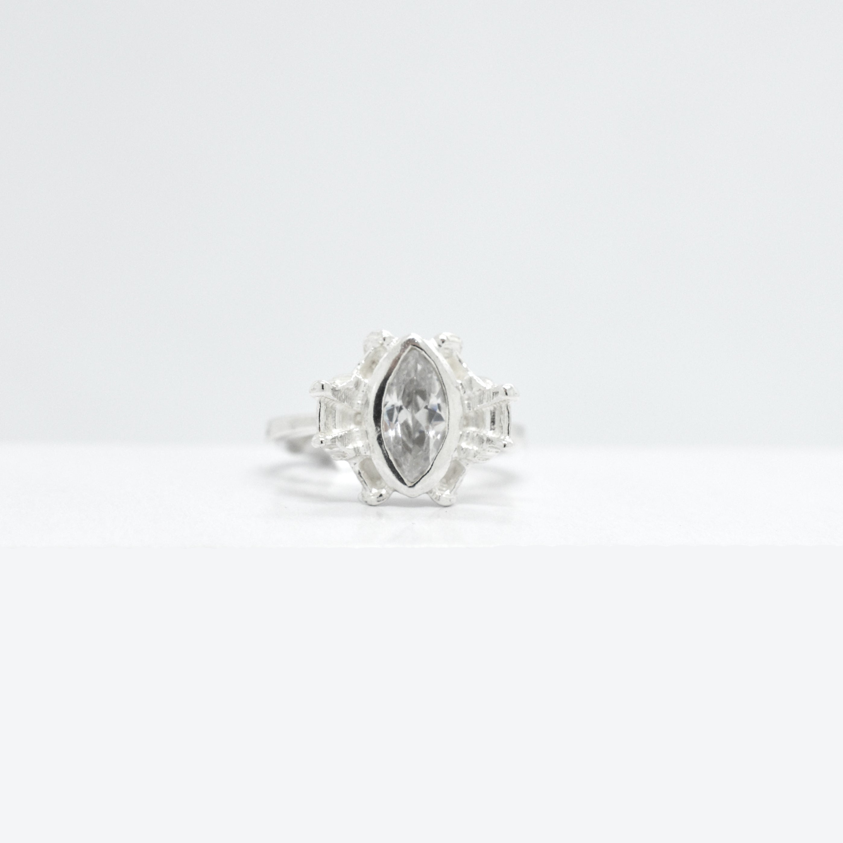 Silver ring with a large marquise shaped cubic zirconia on a  white background