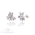 Silver flower-shaped earrings on a white background with 'Elaine McKay Jewellery' branding.