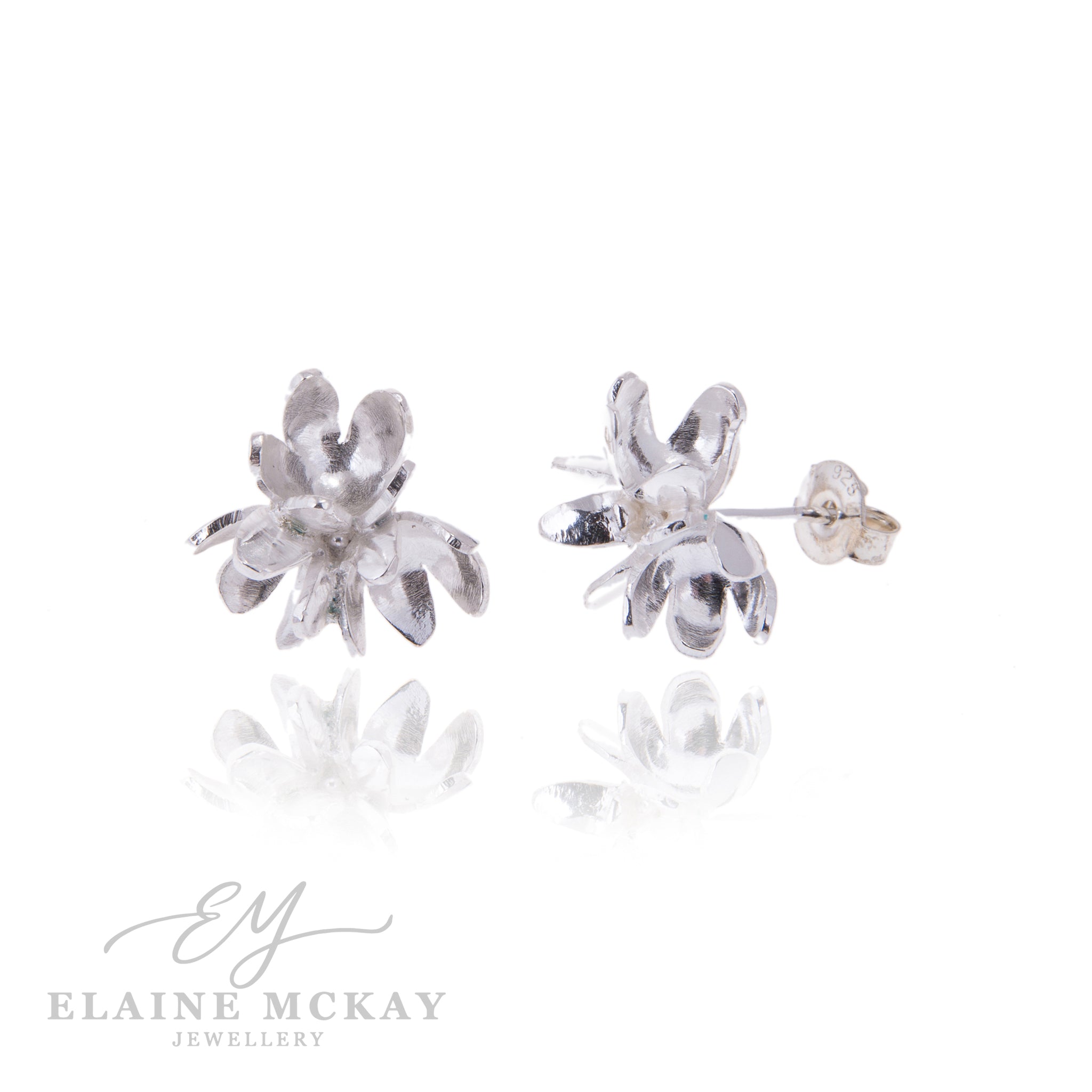 Silver flower-shaped earrings on a white background with 'Elaine McKay Jewellery' branding.
