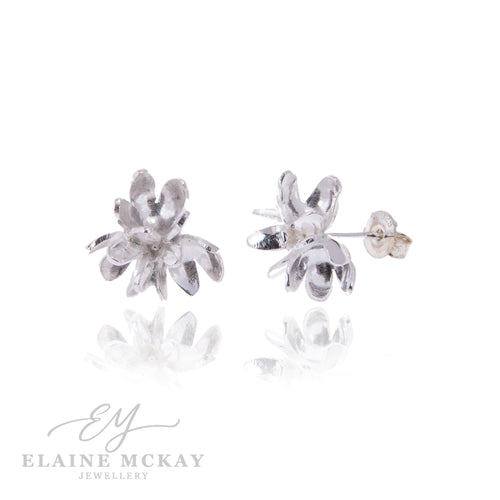 Silver flower-shaped earrings on a white background with 'Elaine McKay Jewellery' branding.