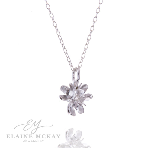 Silver necklace with a floral pendant on a white background, branded 'Elaine McKay Jewellery'.