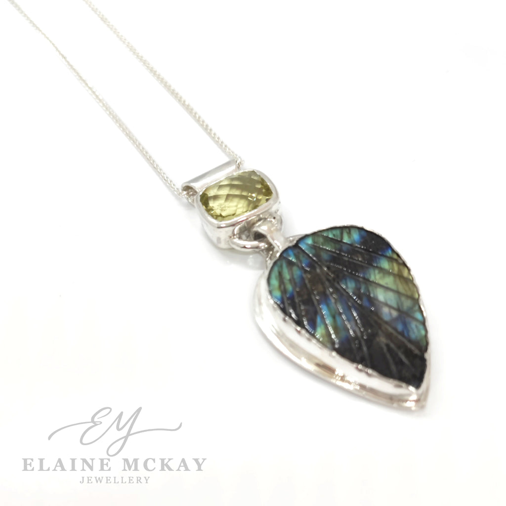 Jewelry pendant with lemon quartz and labradorite gemstone and silver chain on a white background, branded 'Elaine McKay Jewelry'.